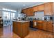 Well-lit kitchen features wood cabinetry, island, and stainless steel appliances at 420 Beverly Ct, Carmel, IN 46032