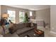 Cozy living room with a sectional sofa, carpet flooring, and a view of staircase at 420 Beverly Ct, Carmel, IN 46032