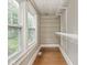 Walk-in closet with custom shelving and hardwood floors provides ample storage space and organization at 4455 Central Ave, Indianapolis, IN 46205
