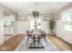 Dining room with a modern chandelier, hardwood floors, and natural light at 4455 Central Ave, Indianapolis, IN 46205