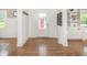Bright foyer with beautiful hardwood floors, built-in shelves, and view to the backyard at 4455 Central Ave, Indianapolis, IN 46205