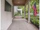 Spacious front porch with wood ceiling and brick accents offering a relaxing outdoor space at 4455 Central Ave, Indianapolis, IN 46205
