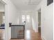 Upstairs hallway with hardwood floors and natural light from nearby windows at 4455 Central Ave, Indianapolis, IN 46205