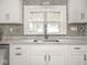Modern kitchen featuring granite countertops, mosaic backsplash, and a stainless steel sink at 4455 Central Ave, Indianapolis, IN 46205