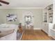 Comfortable living room featuring hardwood floors, built-in bookshelves, and arched doorways at 4455 Central Ave, Indianapolis, IN 46205