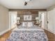Bedroom with wood accent wall, decorative bedding and bedside tables with lamps at 4455 Central Ave, Indianapolis, IN 46205