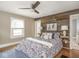 Bedroom with wood accent wall, decorative bedding and bedside tables with lamps at 4455 Central Ave, Indianapolis, IN 46205