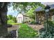 Landscaped backyard with storage shed, pathway, and mature trees for a serene outdoor space at 47 Oakwood Ct, Brownsburg, IN 46112
