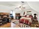 Bedroom featuring rustic stone accent wall, ceiling fan and room for a desk or seating area at 47 Oakwood Ct, Brownsburg, IN 46112