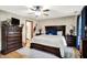 Spacious bedroom boasts a large bed, dresser, and soft white rug on hardwood floor at 47 Oakwood Ct, Brownsburg, IN 46112