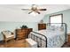 Inviting bedroom features wooden dressers, wicker chair and patterned bedding at 47 Oakwood Ct, Brownsburg, IN 46112