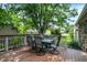 Spacious wooden deck area featuring an outdoor dining area and shade trees at 47 Oakwood Ct, Brownsburg, IN 46112
