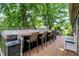 Spacious wooden deck area featuring a bar area and hot tub with shade trees at 47 Oakwood Ct, Brownsburg, IN 46112