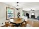 A dining room with a wooden table and chairs beneath a modern light fixture near a sliding glass door at 47 Oakwood Ct, Brownsburg, IN 46112