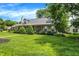 Inviting single-story brick home featuring lush green lawn, mature trees, and tasteful landscaping at 47 Oakwood Ct, Brownsburg, IN 46112