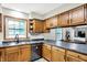 Kitchen featuring stainless steel appliances, wood cabinets, and sink with a window at 47 Oakwood Ct, Brownsburg, IN 46112