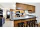 Traditional kitchen with wooden cabinets, stainless steel appliances, and breakfast bar with black stools at 47 Oakwood Ct, Brownsburg, IN 46112