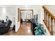 Open-concept living room with hardwood floors, neutral walls, and a view into the dining area at 47 Oakwood Ct, Brownsburg, IN 46112