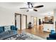 Bright living room with hardwood floors, ceiling fan, and open access to the kitchen at 47 Oakwood Ct, Brownsburg, IN 46112
