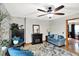 Bright living room with a ceiling fan, fireplace, blue chairs and a sofa at 47 Oakwood Ct, Brownsburg, IN 46112