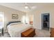 Cozy bedroom with a large bed, ceiling fan, and connecting bathroom and closet at 5229 Imperial Dr, Columbus, IN 47203