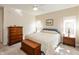 Bedroom showcasing a bed, dresser, nightstands with lamps, and ample natural light at 5229 Imperial Dr, Columbus, IN 47203
