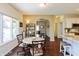 Warm dining area with arched doorway and seating near a sunny window at 5229 Imperial Dr, Columbus, IN 47203