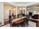 Spacious dining room with adjacent living areas with a decorative table runner centerpiece at 5229 Imperial Dr, Columbus, IN 47203