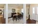 Bright dining room featuring a dark wood table and adjacent kitchen access at 5229 Imperial Dr, Columbus, IN 47203