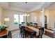 Charming dining area with large window, elegant chandelier, and a dark wood table at 5229 Imperial Dr, Columbus, IN 47203