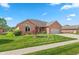Charming brick home with well-manicured lawn and attached two car garage at 5229 Imperial Dr, Columbus, IN 47203