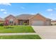Charming brick home with a manicured lawn, attached garage and beautiful landscaping at 5229 Imperial Dr, Columbus, IN 47203