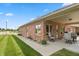 Inviting covered patio with brick finish, comfortable seating, and manicured lawn at 5229 Imperial Dr, Columbus, IN 47203