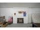 A close view of the fireplace in the unfinished basement with storage and decorations at 5435 E 10Th St, Indianapolis, IN 46219
