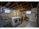 Unfinished basement with utility sink and washer and dryer hookups at 5435 E 10Th St, Indianapolis, IN 46219