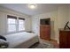 Cozy bedroom with hardwood floors, natural light, and neutral decor at 5435 E 10Th St, Indianapolis, IN 46219