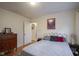 Bedroom with wood floors, white painted bed frame, and neutral wall color at 5435 E 10Th St, Indianapolis, IN 46219