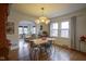 Inviting dining area with hardwood floors, modern lighting, and ample natural light at 5435 E 10Th St, Indianapolis, IN 46219