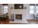 Cozy living room fireplace with white brick surround and mantel, perfect for relaxation at 5435 E 10Th St, Indianapolis, IN 46219