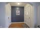 Welcoming foyer featuring hardwood floors, fresh paint, and a classic front door at 5435 E 10Th St, Indianapolis, IN 46219