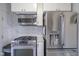 View of the stainless steel refrigerator, microwave and gas range in the kitchen at 5435 E 10Th St, Indianapolis, IN 46219