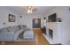 Spacious living room with a fireplace, hardwood floors, and seamless flow into other living areas at 5435 E 10Th St, Indianapolis, IN 46219