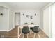 Bright dining area with modern table and chairs, featuring hardwood floors and ample natural light at 5516 W Minnesota St, Indianapolis, IN 46241