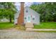Charming home with blue front door, brick chimney, gray siding, and well-maintained front yard at 5516 W Minnesota St, Indianapolis, IN 46241