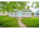 Charming single-story home with light gray siding and a welcoming turquoise front door at 5516 W Minnesota St, Indianapolis, IN 46241