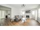 Bright living room with hardwood floors and a cozy fireplace with white painted brick at 5516 W Minnesota St, Indianapolis, IN 46241