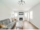 Bright living room with hardwood floors and modern decorative fireplace with TV at 5516 W Minnesota St, Indianapolis, IN 46241