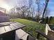A backyard with an in-ground fire pit and landscaped lawn at 5686 Ellie Ct, Noblesville, IN 46062
