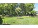 Beautifully landscaped backyard with mature trees, shrubs, and manicured lawn at 5686 Ellie Ct, Noblesville, IN 46062