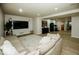 A cozy basement with a large sectional sofa, plush rug, and entertainment setup, perfect for relaxation and leisure at 5686 Ellie Ct, Noblesville, IN 46062